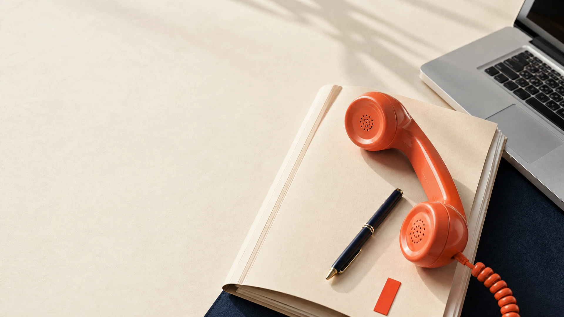 Orange phone handset resting on a concierge case file
